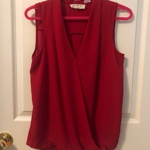 Red sleeveless blouse.